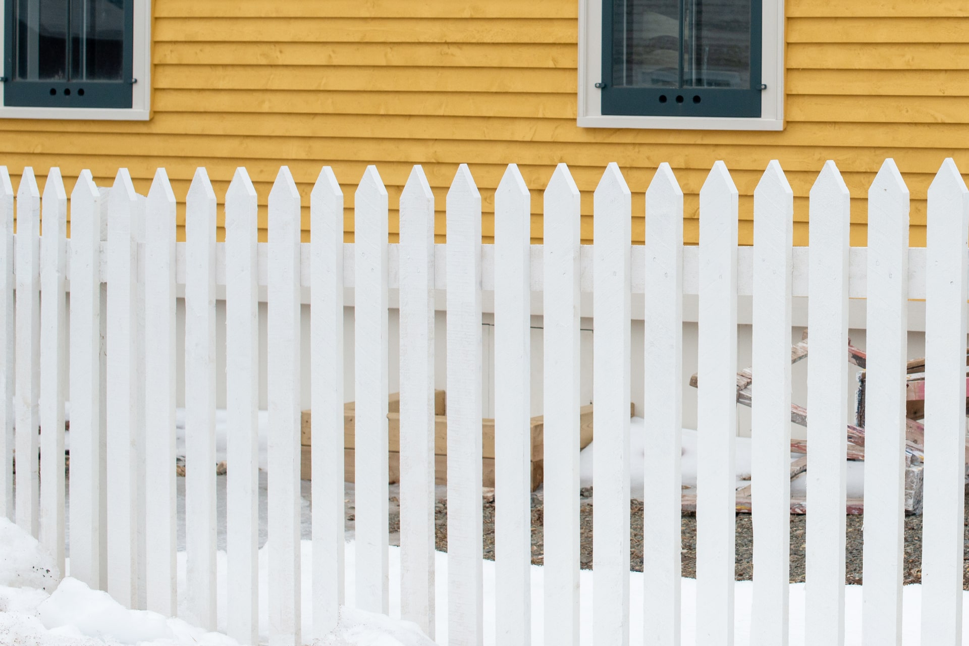 Straight picket vinyl fence by Top Rail Fence