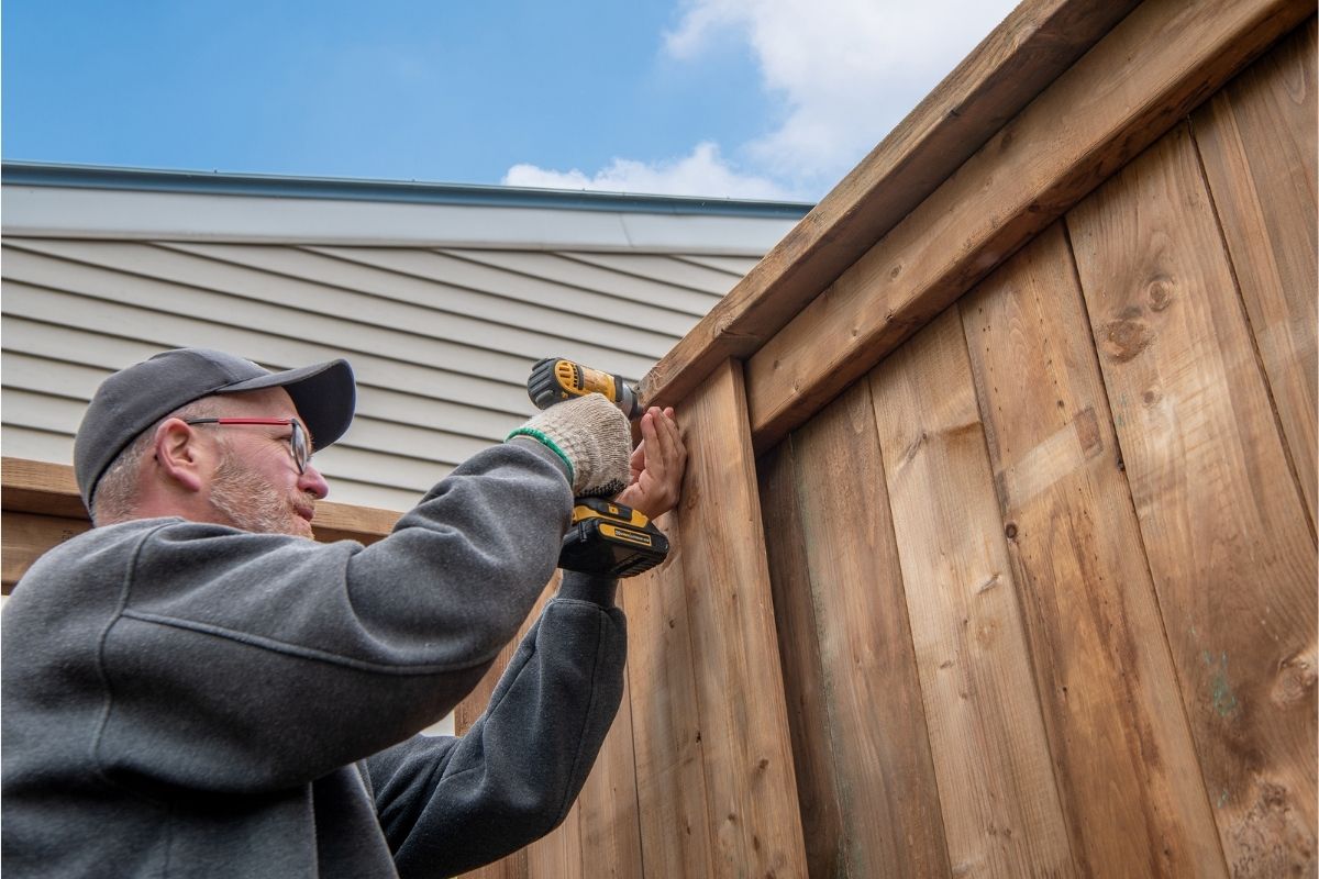 man building a fence